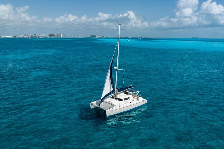 Sail across the dazzling turquoise waters with the Cancún skyline as your backdrop on your private catamaran charter!