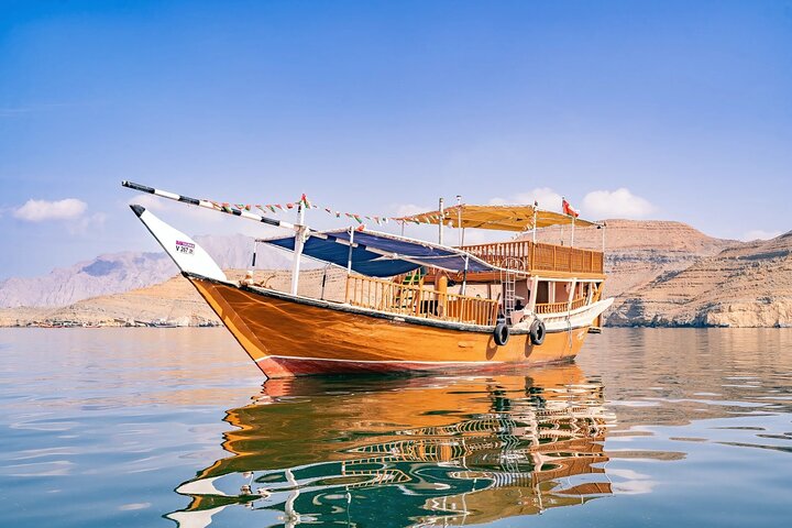 Set sail for adventure! Experience the best of Musandam on a classic Dhow cruise, where dolphin watching and snorkeling in the stunning fjords await. Book your perfect day trip!