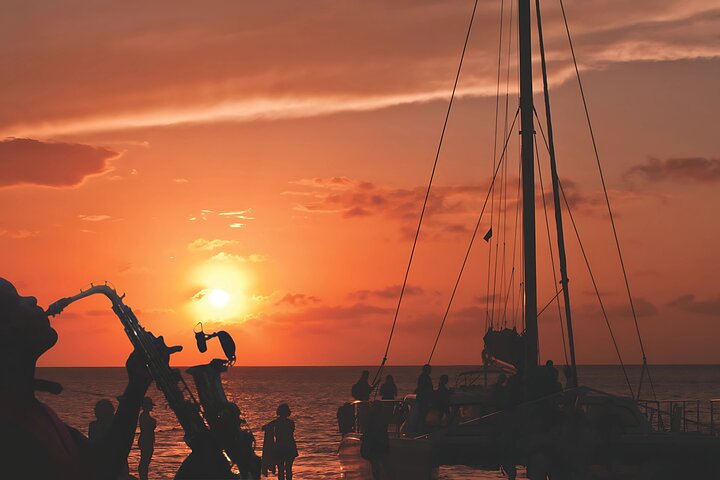 Sail into the golden horizon and enjoy a romantic evening with a sunset serenade on the Montego Bay Sunset Catamaran Cruise!